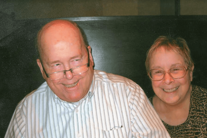 Ian M. Finlayson, a balding older man with glasses near the end of the bridge of his nose; wearing a pin-striped shirt; and Kathleen VanPaaschen, on older woman with gold-brown hair; wearing glasses at the top of her nose. Both people are against a grey background.