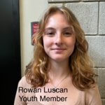 Rowan Luscan, Youth Member, Caucasian youth with blond curly hair; wearing a tan blouse and a gold necklace