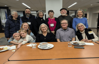 N2N members sharing a meal at a table in the lower level of FUUR